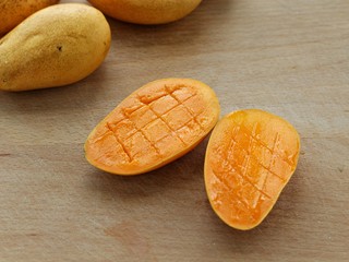 2、芒果布丁,将芒果对半切开划十字刀