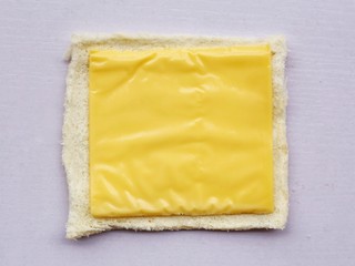 5、爆浆芝士火腿土司卷,铺上芝士。