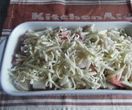 5、黄金海鲜焗饭,将做法4.倒入放有炒饭的烤盘里，铺在炒饭上面，将芝士条均匀地洒在炒饭上