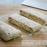 7、花生牛扎糖,如图在案板上撒点奶粉将牛轧糖切成小块
