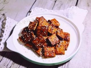 8、蜜汁豆干,拌匀，撒上熟芝麻即可。