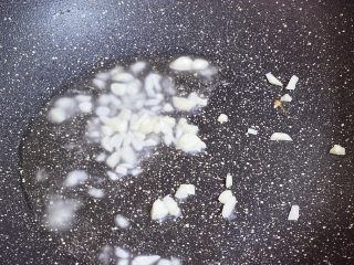 8、青椒火腿肠炒鸡蛋,原锅倒入适量的食用油烧热,放入蒜末爆香