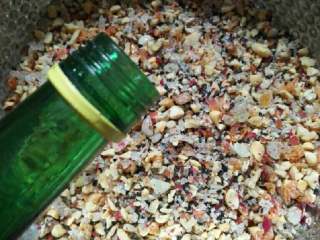 6、五仁月饼,全部放入大盆中，掰入玫瑰花瓣，加入白酒，玉米油，纯净水然后充分搅拌均匀。