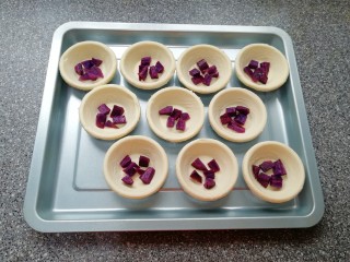 7、紫薯蛋挞,提前解冻的蛋挞皮摆在烤盘里，放上蒸好的紫薯。