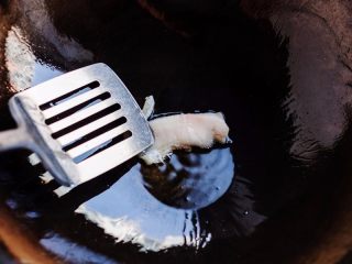 3、鲫鱼萝卜奶白汤,炒锅烧热放进肥肉片，用锅铲按压着煎出油，晃动锅使油沾满锅底。