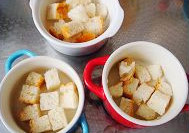 5、面包布丁,把吐司放入烤碗中，加入过滤好的布丁液，9分满就可以。