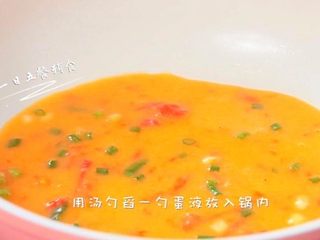 6、番茄土豆银鱼厚蛋烧,用大勺舀一勺蛋液放入锅内，迅速晃动锅使蛋液均匀铺满锅底，小火煎至蛋液表面凝固。