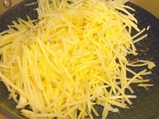 22、春饼卷土豆丝,然后把土豆丝沥水之后，放进锅里。不停翻炒。很爱糊锅哦。