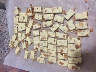 7、牛轧糖,压好后拿出，先切成长条，在按照糖纸的大小切成小块