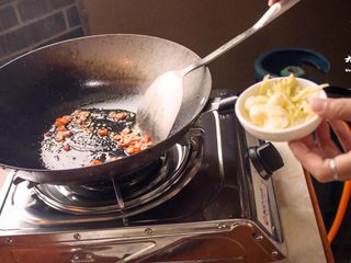 4、暴走鱿鱼卷螺蛳粉丨大嘴螺,炒锅内加入适量油,油热后加红辣椒,之后立即放入姜蒜及螺蛳粉内调料包配料翻炒。炒出香味后倒入煮好的米粉,不一会可出锅。PS:即使没有填充鱿鱼那