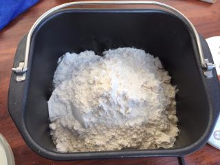 2、青南瓜肉包,把面粉，加入到面包机中，慢慢的倒入酵母水；