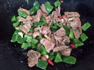 15、爆炒牛肉,加入青椒一起翻炒。