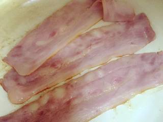 3、小芽早餐-芦笋培根土豆泥,取3-4片培根，可以中间对切一下。热锅，锅底抹一层薄油，把培根肉平铺在锅底，小火一点点煎（小火控制哈），等培根肉有点出油，边上略金黄即可。