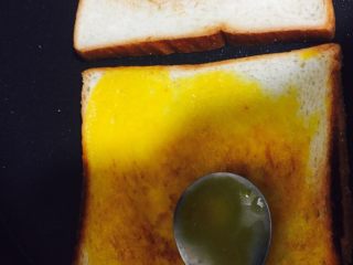 6、好好ci牌鸡蛋吐司,涂抹均匀 不要太多 不然 不好翻面 抹均后 稍等片刻 用筷子 或者木铲 给它翻个面 喜欢双面的就再抹另外一面 我比较喜欢单面 双面 没有脆感 OK 煎好就完事啦 撒盐啊 番茄酱 什么酱都可以 我喜欢盐????????