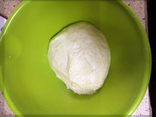 3、鸡肉芝心披萨,揉搓至面团后加入黄油。再次揉搓。一般揉20分钟-30分钟就可以了。然后让入温暖的环境发酵。一般是盖上保鲜膜放入有热水的烤箱。20分钟可以。