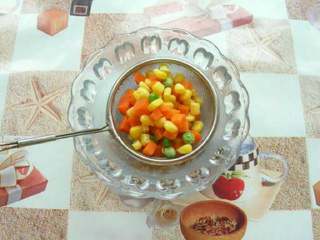 4、土豆沙拉,准备玉米 把罐头玉米放进笊篱里排出水分，开水焯一下。