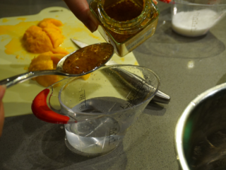 4、千层椰汁桂花糕,把桂花糖舀进冻水里并搅拌均匀