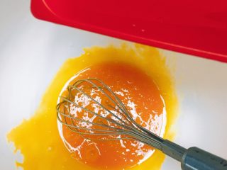 3、吃起来满口幸福感的蔓越莓戚风蛋糕,蛋黄搅匀之后加入玉米油，搅拌均匀。