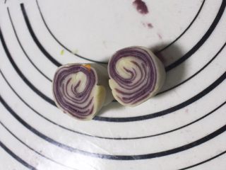 11、旋风紫薯油酥烧饼,然后将擀好的剂子从中间切开，就可以看到很漂亮的螺旋状花纹了