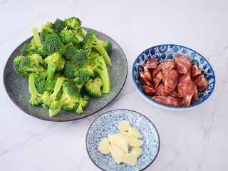 2、西兰花炒腊肠,西兰花切成小朵用盐水浸泡十分钟后再冲洗干净备用，腊肠切片，蒜切片