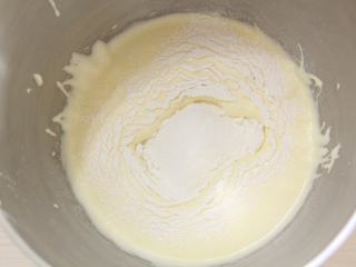 6、抹茶心形小蛋糕,一次性筛入低筋面粉，用橡皮刮刀由底部向上翻拌均匀。