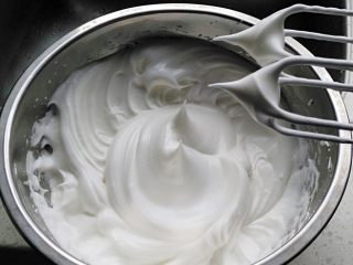 2、蛋糕甜甜圈,将蛋清分三次加入60克白糖，打发至干性发泡