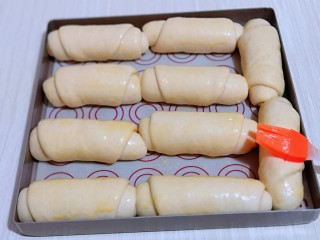 11、葱香四溢的全麦酸奶面包卷,发酵至原来的两倍大，刷上一层蛋液。