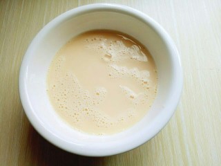 5、水果千层蛋糕,加入牛奶，用手动打蛋器抽打均匀。(使牛奶和鸡蛋完全融合)