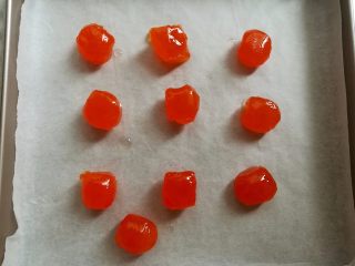 11、广式红豆沙蛋黄月饼,把咸蛋黄放到垫了油纸的烤盘里