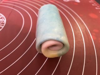 11、彩虹蛋黄酥,哪个颜色为中心就从哪一头卷起，收口朝下摆好，依次做好六个