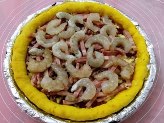 10、南瓜虾仁培根披萨,上面撒紫洋葱碎，培根条，铺虾仁，入烤箱200度烤10分钟