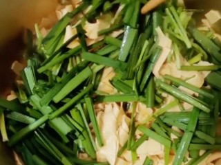 18、韭菜炒干豆腐,放入韭菜翻炒均匀即可。