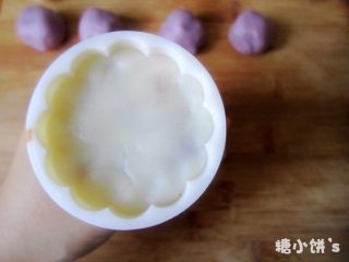 10、低糖低油【紫薯冰皮月饼】,再取一个步骤8包好的月饼坯压入步骤9压过紫色面团的模具中，将底部压平