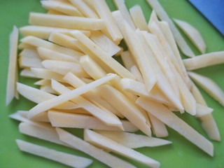 4、美式芝香薯条,再将土豆片切成1cm宽的长条。