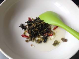 10、元宵节-雪菜炒汤圆,另起油锅中小火爆香蒜末和干辣椒,倒入咸菜煸炒出香味