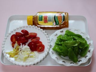 4、荷兰豆海鲜烩芋圆,把荷兰豆摘洗干净后用手撕两半，小番茄一切两开，葱姜切碎备用。