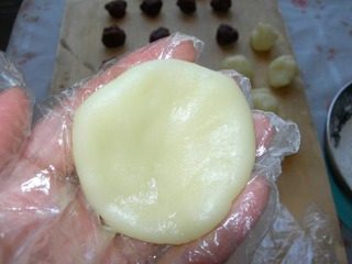 14、冰皮豆沙月饼,取一个冰皮剂子，用手压成小圆饼