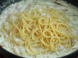 11、奶油蘑菇培根意面,将煮好的意面捞出放入锅中拌匀