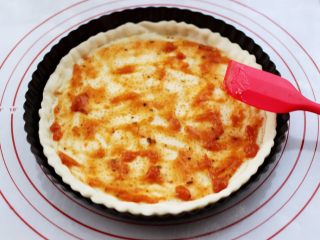 11、海虾杂蔬披萨,烤好定型后的披萨面皮从烤箱取出以后,先加入披萨酱后,用铲子把披萨酱抹均匀。