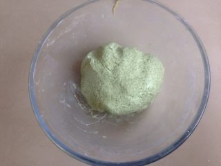 8、清明时节艾糍香,再根据粉团的软硬度逐少量添加温水55g,和成软硬适中的粉团,不干不湿不粘手,用保鲜膜盖住