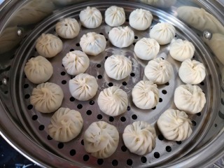 12、冬至美食  饺子皮小笼包,蒸锅内放水，篦子上刷上一层食用油，放上包好的小笼包。