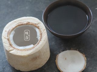 2、椰子海鲜芝士焗饭,把椰青劈开一个盖子,椰子水倒出,这个时候可以先准备米饭,用椰子水来煮饭,一个椰青就是一个人份量,半杯米就行了;