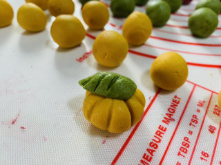 10、南瓜汤圆,将叶子轻轻压在南瓜样子的糯米团上