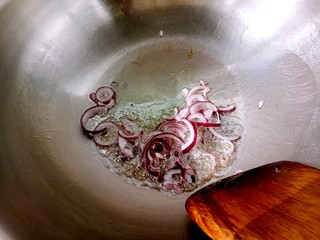 2、大虾披萨,锅热放色拉油，放入洋葱碎，翻炒几下。