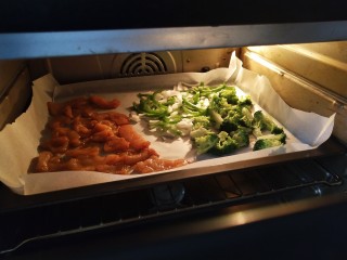 6、全麦披萨低脂营养,把腌制好的鸡胸肉和洋葱青椒西蓝花，全部铺在烤盘上，菜肉分开，200度烤10分钟脱水