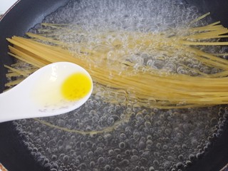 3、香菇意面,再放一勺橄榄油，这样做是为了防止意面粘粘。煮出来更有韧性。