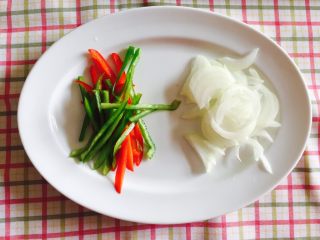 2、“黑胡椒培根牛肉粒意面”,洋葱头、青椒、红椒分别切丝待用。