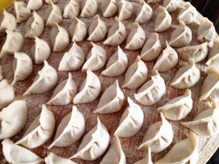 16、水饺,把盖帘撒上面粉，包好的饺子摆放在上面，这样就不会粘了，