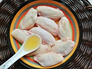 3、照烧柠檬鸡翅,鸡翅放入盘中，倒入三勺料酒。