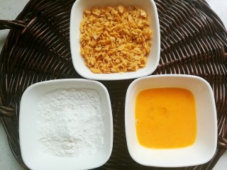 10、薯片鸡翅,把碾碎的薯片放入碗中，另外准备好面粉和打散的鸡蛋。